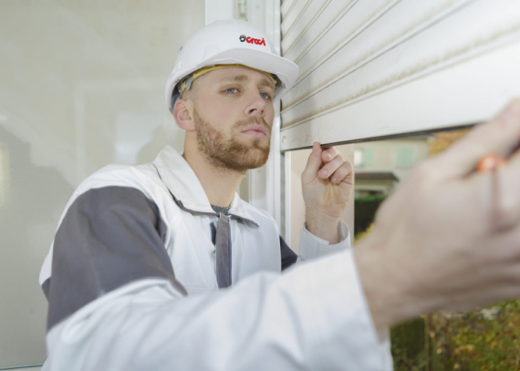 Worker inspecting shutter