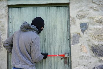Man attempting to break into a homes front door