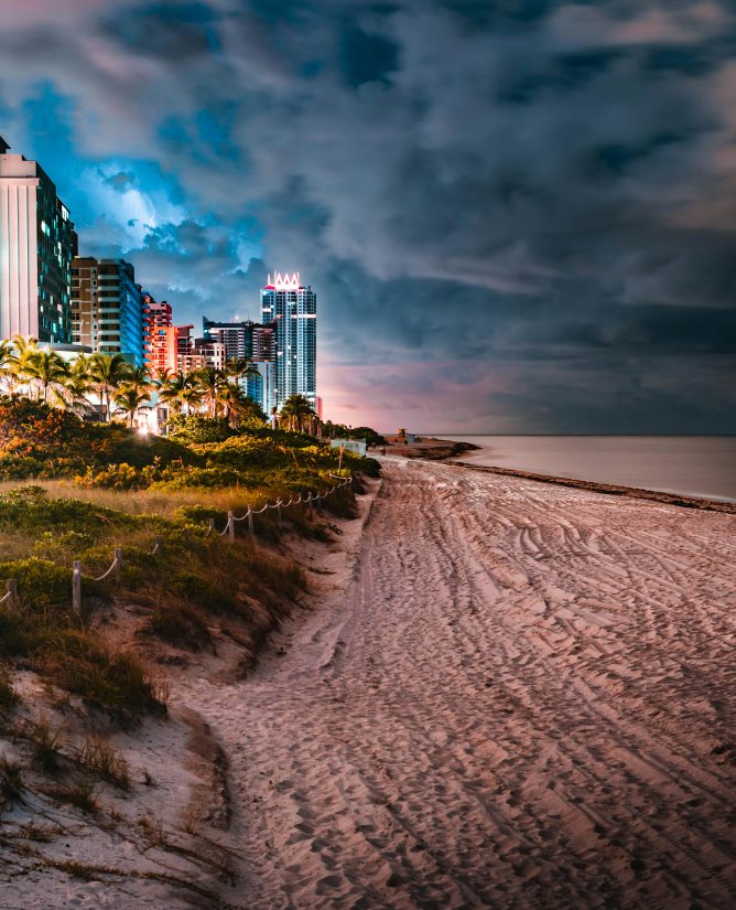 Hurricane approaching the Florida coast with dark storm clouds and rough ocean waves.